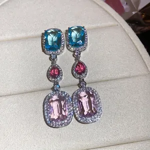 Elegant silver needle drop earrings featuring colorful oval and teardrop zircons