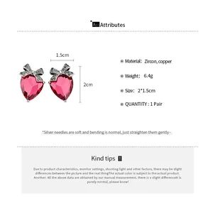 Detailed view of pink heart zircon earrings with bow including size and material info
