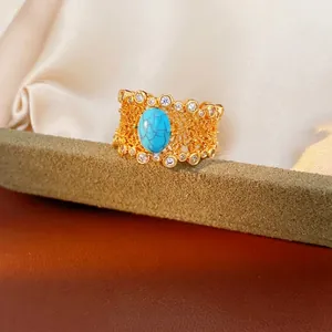 Vintage gold plated filigree ring with oval turquoise stone and sparkling zircons