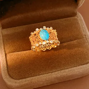 Macro view of vintage gold-plated ring with turquoise and zircon in a velvet jewelry box