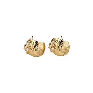 Elegant 18k gold plated flower stud earrings with shimmering zircons and textured finish.