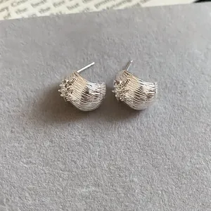 Detailed view of elegant silver flower stud earrings featuring sparkling zircon accents
