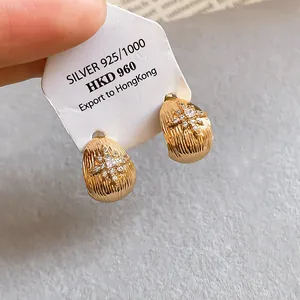 Close-up of elegant 18k gold plated stud earrings with star-shaped cubic zirconia detail