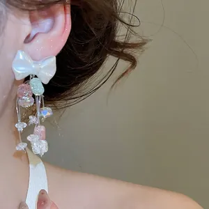 Boucles d'oreilles nœud doux avec pompons en cristal et perles style princesse élégant