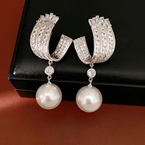 Elegant geometric U-shape pearl earrings with shimmering zirconia accents