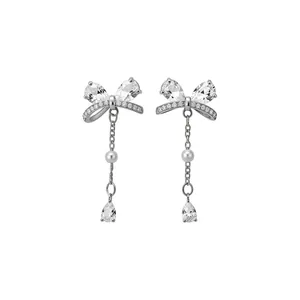 Elegant silver bow stud earrings with sparkling zircons and dangling white pearl tassels