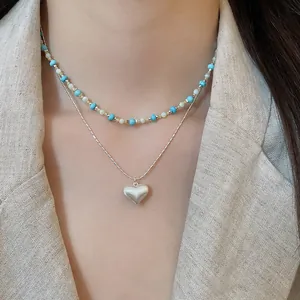 Detailed view of French vintage layered turquoise beaded necklace with heart pendant