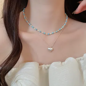 Detailed shot of a French vintage layered necklace with turquoise beads and heart pendant
