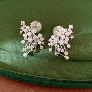 Elegant silver zircon pearl non-pierced ear clips for women on green velvet background