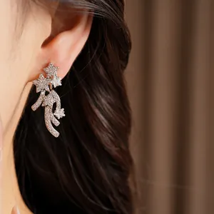 Close-up detail of silver shooting star earrings encrusted with sparkling cubic zirconia