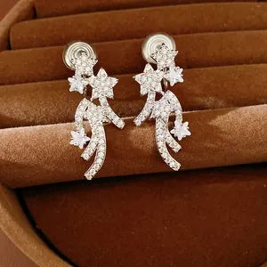 Macro detail of star-shaped silver clip-on earrings encrusted with shimmering pavé zircon