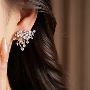 Close-up of elegant zircon and pearl ear clip on model for non-pierced ears styling.