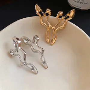 Irregular hollow liquid metal stud earrings with unique design in gold and silver colors