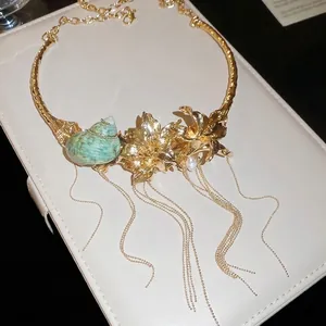 Close-up of high-end luxury gold flower choker necklace with seashell and tassels