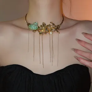 Detailed view of a vintage gold flower and seashell tassel choker necklace on a model
