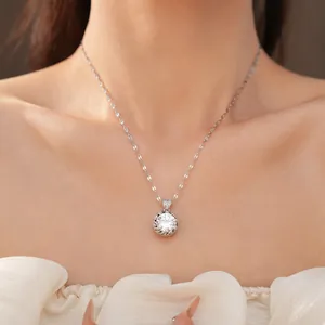 Gros plan d'un collier chaîne en argent avec pendentif rond en zircon sur le cou