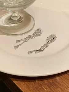 Detailed view of sparkling cubic zirconia tassel earrings with heart and drop shapes