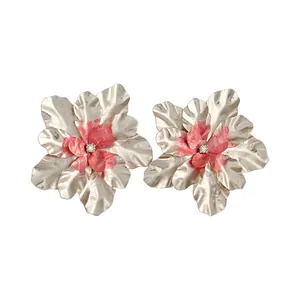 Elegant large flower stud earrings with metallic petals and a pink enamel center.