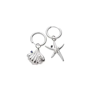 Asymmetrical silver-tone hoop earrings with seashell and starfish nautical charms