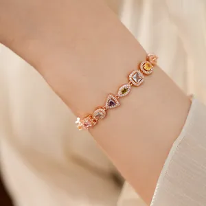 Detailed view of elegant rose gold bracelet with colorful geometric zircons on a wrist