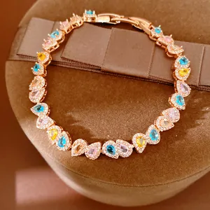 Close-up of rose gold plated bracelet with multi-color teardrop zircons on velvet stand
