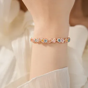 Detailed macro shot of 18k rose gold plated bracelet with colorful teardrop zircons