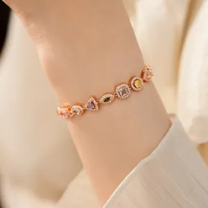 Detailed close-up of a delicate rose gold plated bracelet with colorful geometric zircons.
