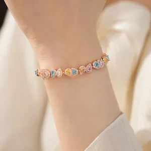 Close-up detail of an 18k gold plated bracelet featuring vibrant multi-colored zircons.