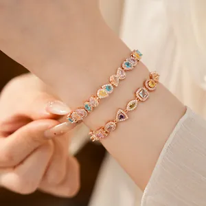 Detailed close-up view of elegant rose gold bracelets with colorful geometric stones
