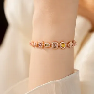 Detailed view of an 18k gold plated geometric bracelet with colorful zircon stones on wrist