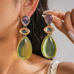 Detailed view of vintage multi-tier resin teardrop earrings with gold-plated frames.