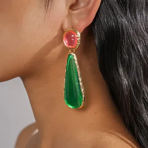 Detail shot of vintage resin teardrop earrings in pink and emerald green finish