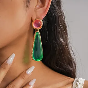 Detailed macro shot of vintage resin teardrop earrings in vibrant pink and green colors