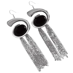 Detailed view of silver spiral snail earrings featuring black stones and chain tassels.