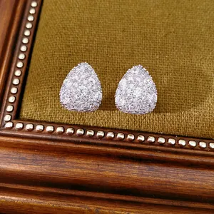 Detailed macro view of water drop stud earrings fully paved with sparkling cubic zirconia