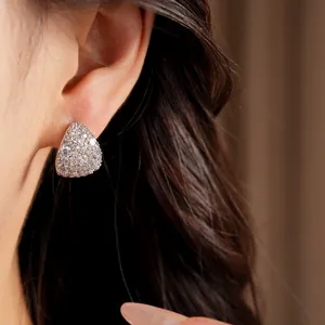 Macro view of elegant waterdrop stud earrings with pavé-set cubic zirconia stones