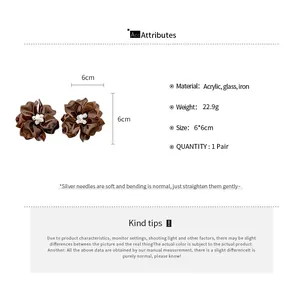 Detailed view of brown acrylic flower earrings with crystal beads and size specifications