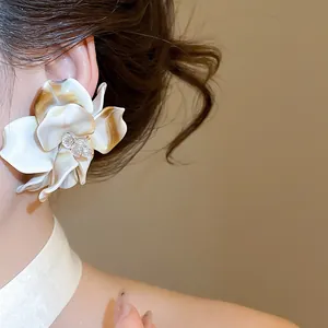 Macro detail of the oversized marble acrylic flower earring featuring a crystal bead center
