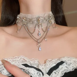Close-up of vintage lace choker with sparkling crystal flower and teardrop pendants.