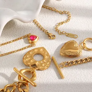 Detailed macro shot of 18K gold plated stainless steel heart bracelets with red stone