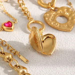 Macro detail of 18K gold plated stainless steel heart locket and red crystal charm