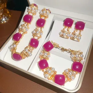 Vintage jewelry set featuring fuchsia resin squares, faux pearls and rhinestones