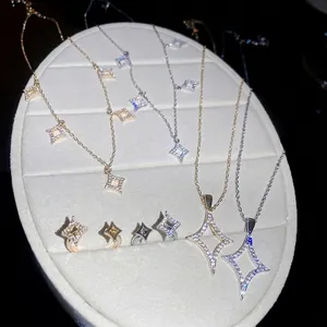 Main view of 18K gold plated zircon star necklace and open ring set on a jewelry display tray