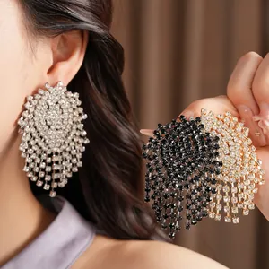 Close-up showing the intricate rhinestone details of these luxury geometric tassel earrings