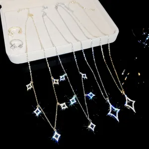 Detailed view of 18K gold plated zircon star necklace and open ring jewelry set