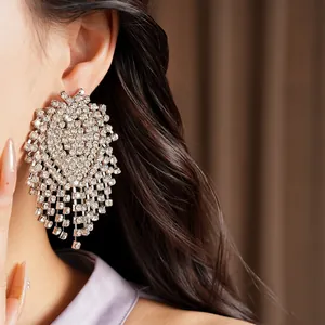 Close-up detail of luxury geometric tassel earrings encrusted with sparkling rhinestones