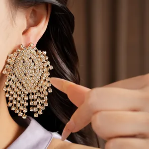 Close-up detail of luxury geometric tassel earrings with brilliant rhinestone inlay