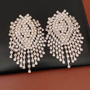 Detailed view of silver needle rhinestone geometric tassel earrings with luxury style
