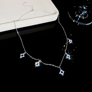 Close-up detail of a delicate silver necklace featuring five sparkling cubic zirconia star pendants