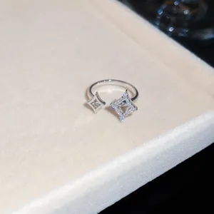 Close-up detail of a sparkling zircon star-shaped open ring on a jewelry display tray
